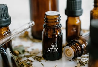 a variety of bottles of atik fragrance oils