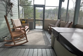 Screened in porch with rocking chairs and 2 person hot tub. 