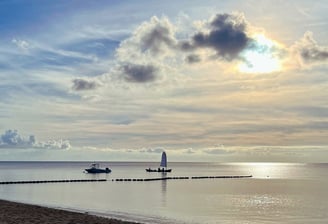 a boat near the beach in the sunset - symbolizing direction and transformation