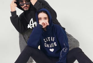 2 people wearing customized hoodies
