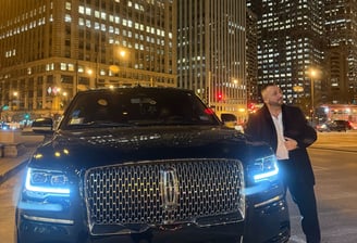 Lucian in front of a Lincoln SUV in Chicago