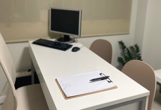 a desk with a computer and a keyboard