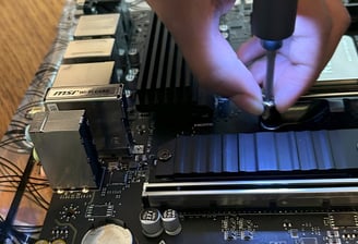 Child attaching a SSD to a motherboard - STEM