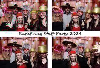 Group of people in costume wigs, hats, and glasses posing for fun photo booth pictures at corporate event by Get The Picture