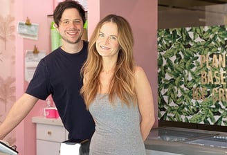 a man and woman standing in front of a counter