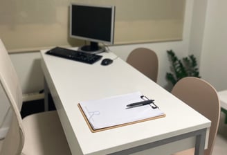 a desk with a computer and a keyboard