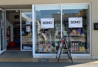 a store front door of a store with a sign that says soho