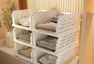 a stack of white plastic containers with towels and towels