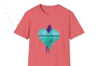 a coral colored graphic tee shirt with a teal heart and a shadow of a girl