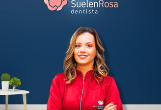 a woman in a red jacket standing in front of a blue wall
