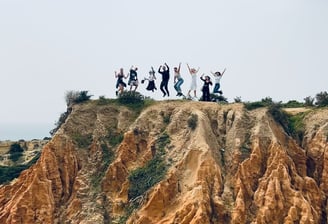Adventure travelers exploring the Seven Hanging Valleys Trail with ocean views in southern Portugal