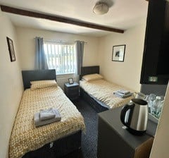 a bedroom with two beds and a coffee maker