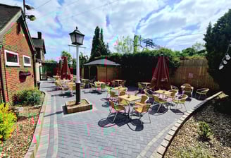 a patio with tables and chairs and umbrellas