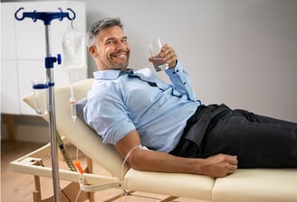 Specialized physician applying IV therapy with essential vitamins to strengthen the body, enhance th