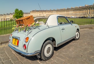 Nissan Figaro classic car with picnic basket