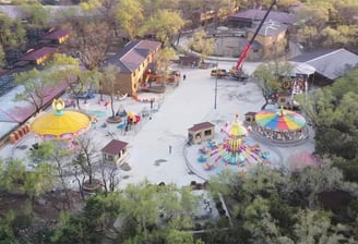 a large area with a large amount of people and a ferris wheel