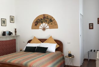 spot of bedroom at the azalea apartment at villa ombrosa