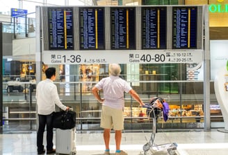 a man and woman standing in front of a sign board