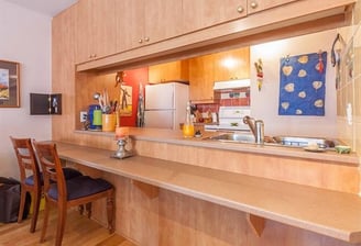 a kitchen with a table and chairs and a refrigerator
