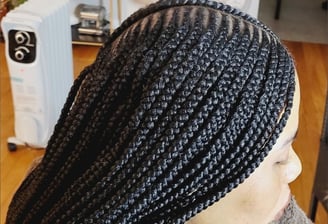 a woman with a large braid braids on her head