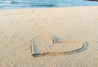 heart drawn on a sandy beach