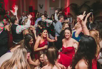 a group of people dancing at a party