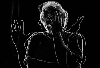 a woman with her hands up and her hands up to her face