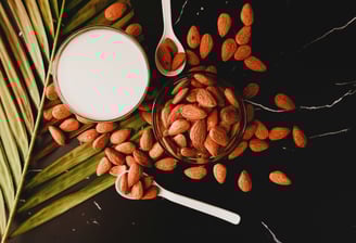 a glass of milk with almonds and almonds