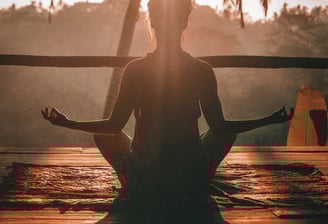 a person sitting in a yoga pose