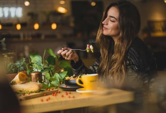a woman is eating a meal in a restaurant