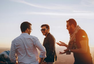 a group of men standing around a table