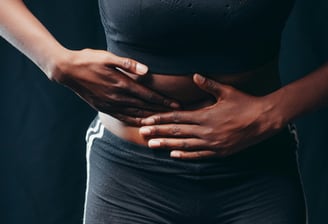 a woman with her hands on her stomach