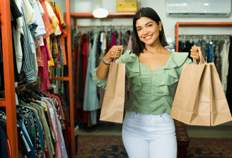 a woman holding shopping bags in a store