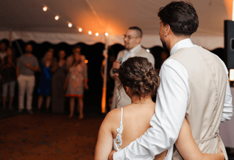 Couple holding each other during wedding toast