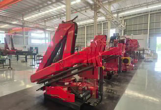 SQZ84B.3 truck-mounted hydraulic knuckle boom loader crane, workshop-ready for diverse lifting tasks.