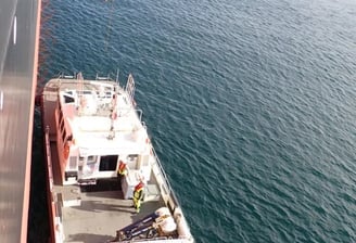 a boat with a crane on it's side and a crane on the side