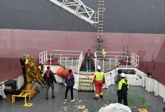 a large ship with a crane on the deck
