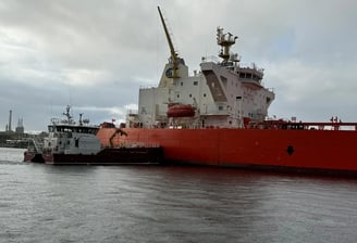 a large red ship in the water