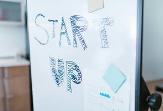 A business whiteboard with the words 'Start Up' on it