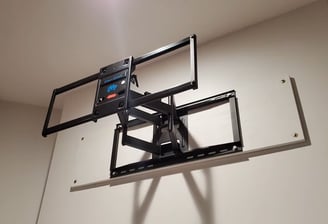A TV mounting over a a board for better grip to the wall
