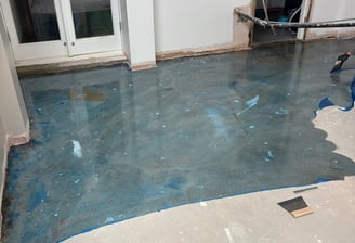 A concrete floor with blue primer