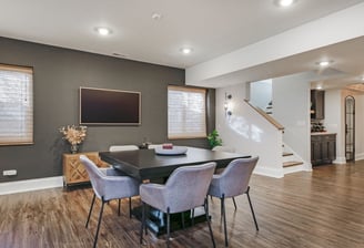Open-concept finished basement in Cumming, Georgia with TV wall and kids’ play area