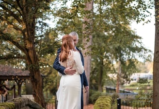 Husband and wife photographed in a forest on their wedding day