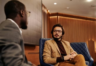 Two men are talking business in a hotel lobby