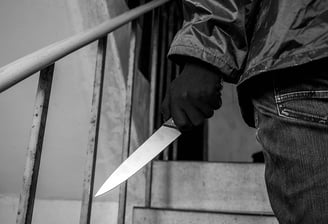 man holding a knife in the stairwell, an edged weapon threat