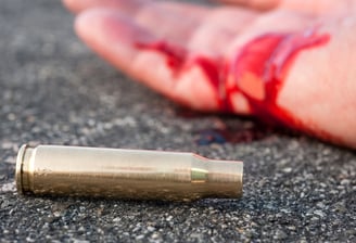 wounded person laying on the street after deadly force used