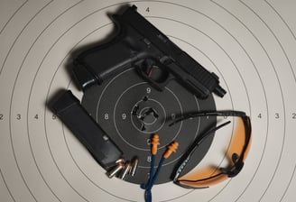 Glock Pistol, ear plugs, safety glasses and accuracy target