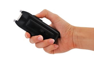Hand holding a Stun Gun ready to deploy for safety