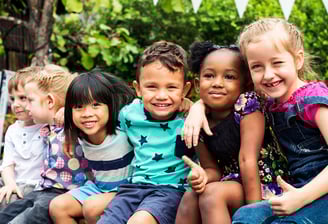 multi-racial children anging out laghing and playing.