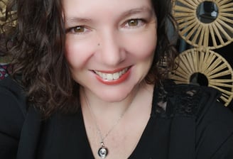 a woman with a necklace and a necklace with a pendant